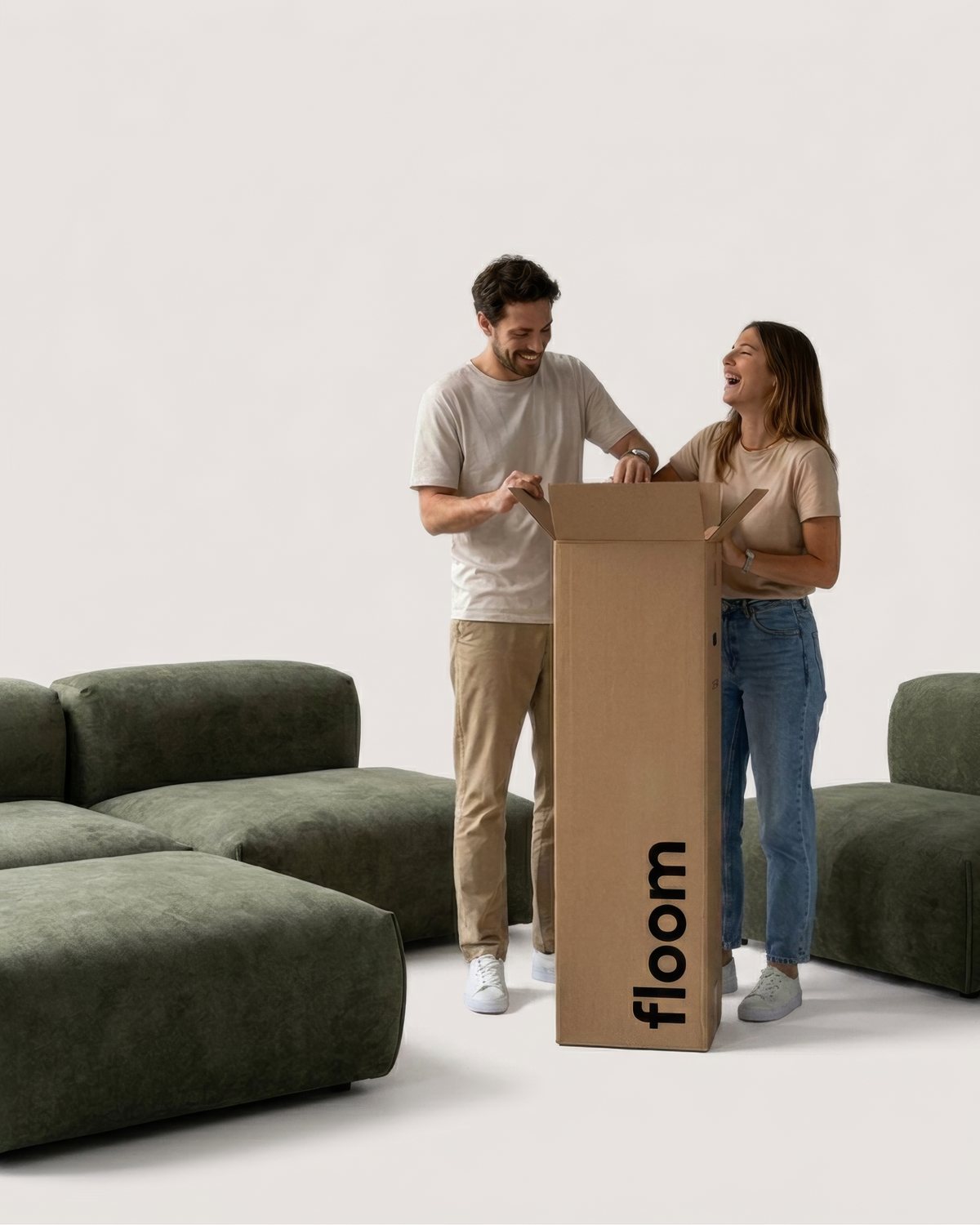 Two people opening the box a Floom sofa arrives in